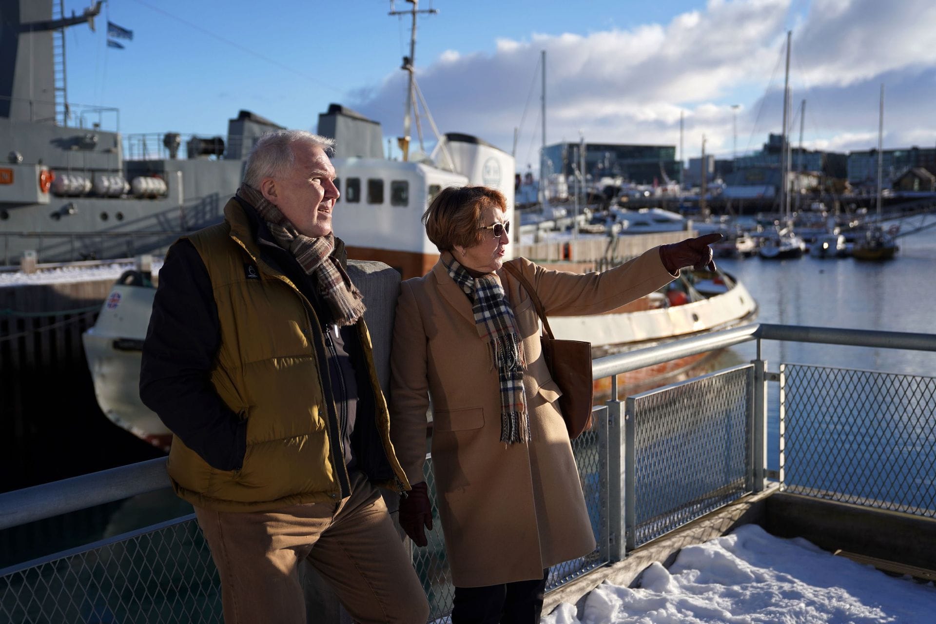 Fólk að tala saman á bryggju og benda